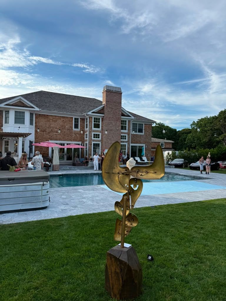 A gold sculptural installation on the lawn overlooking the pool at The Art Affair