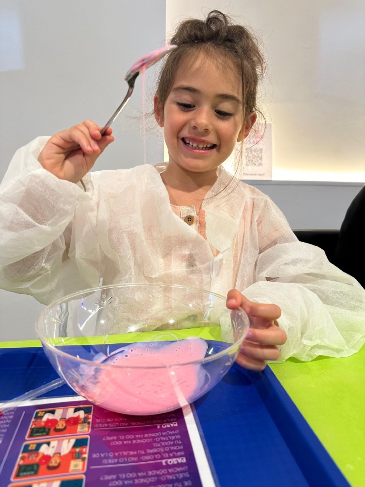 Billie making pink slime at a craft table