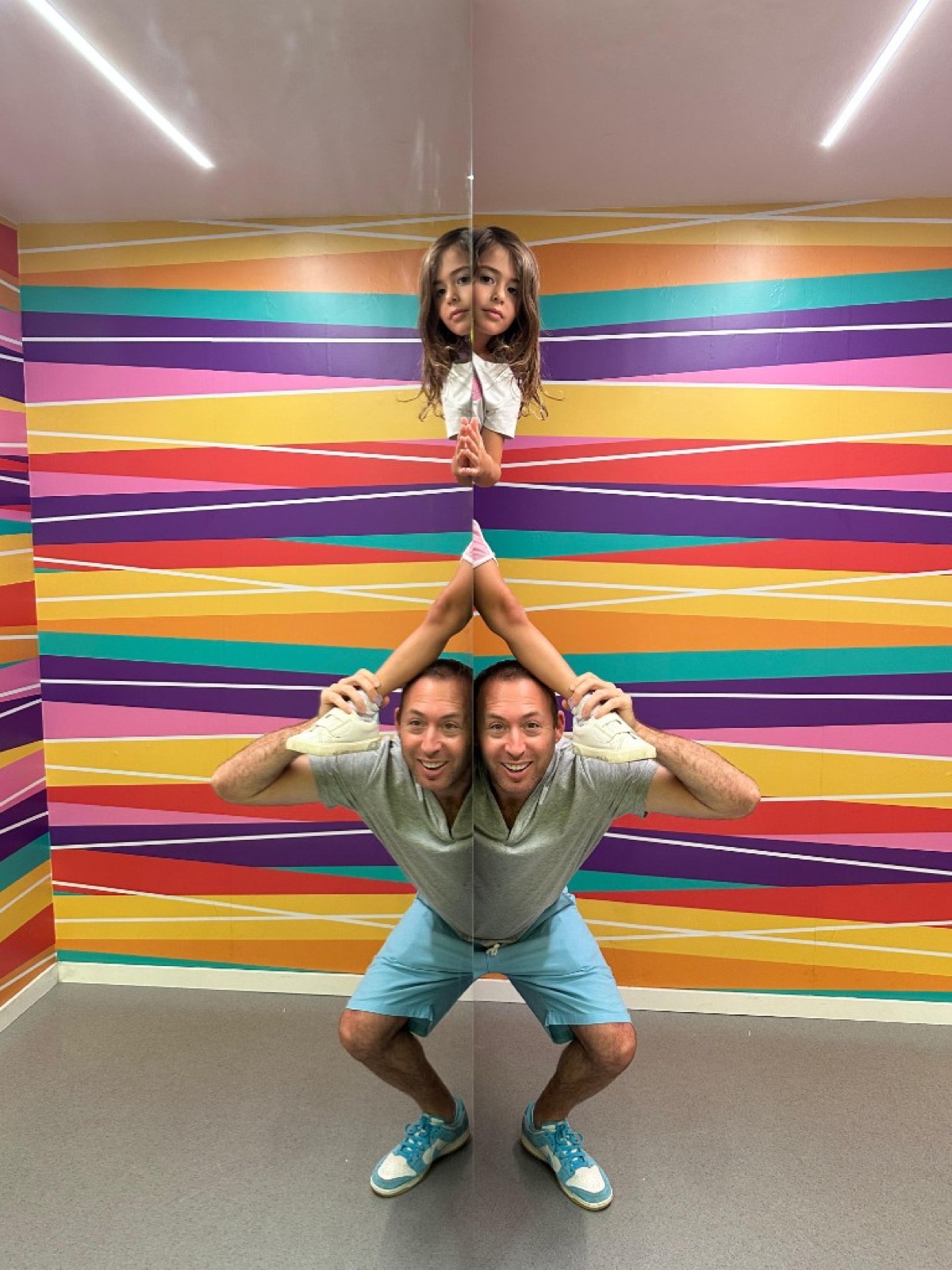 Mike and Billie posing at a colorful illusion museum