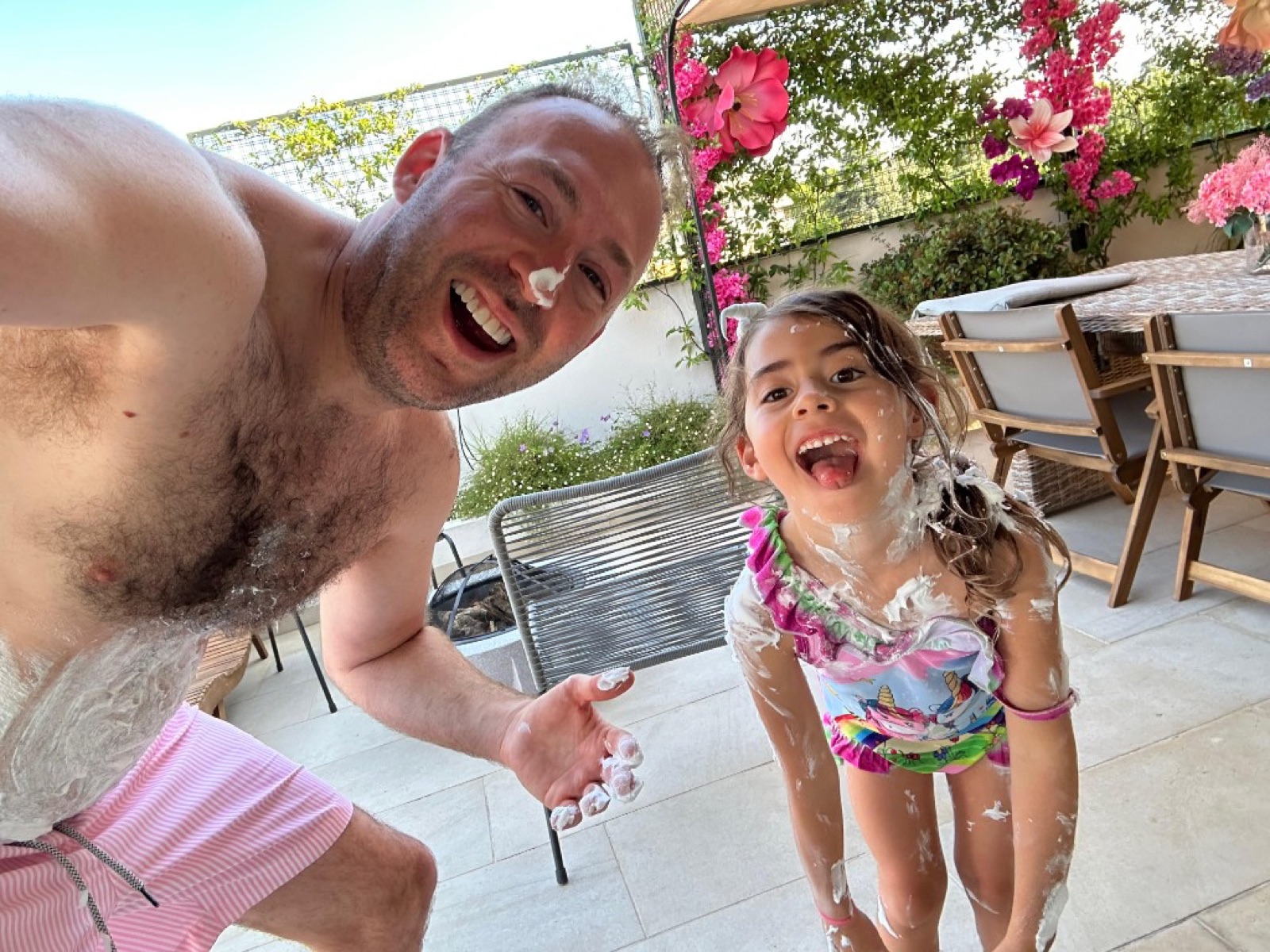 Mike and Billie laughing poolside covered in shaving cream