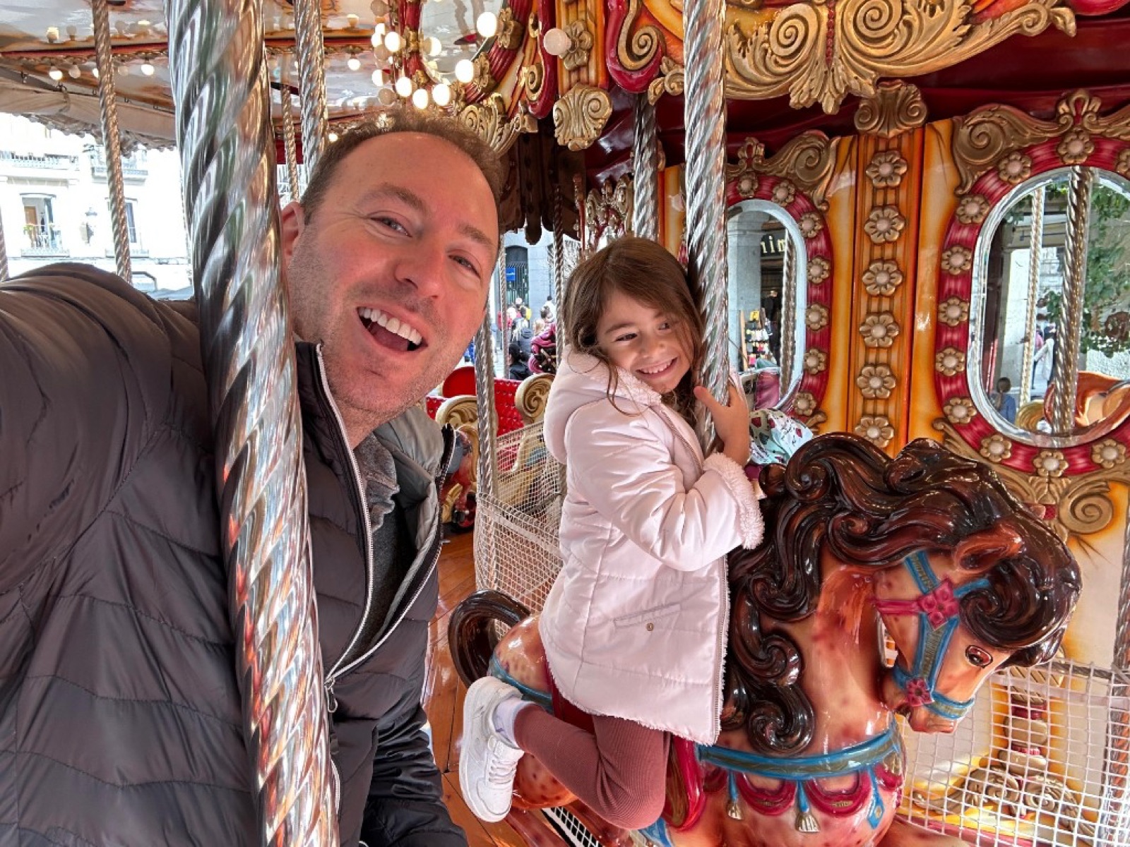 Mike and Billie riding a carousel