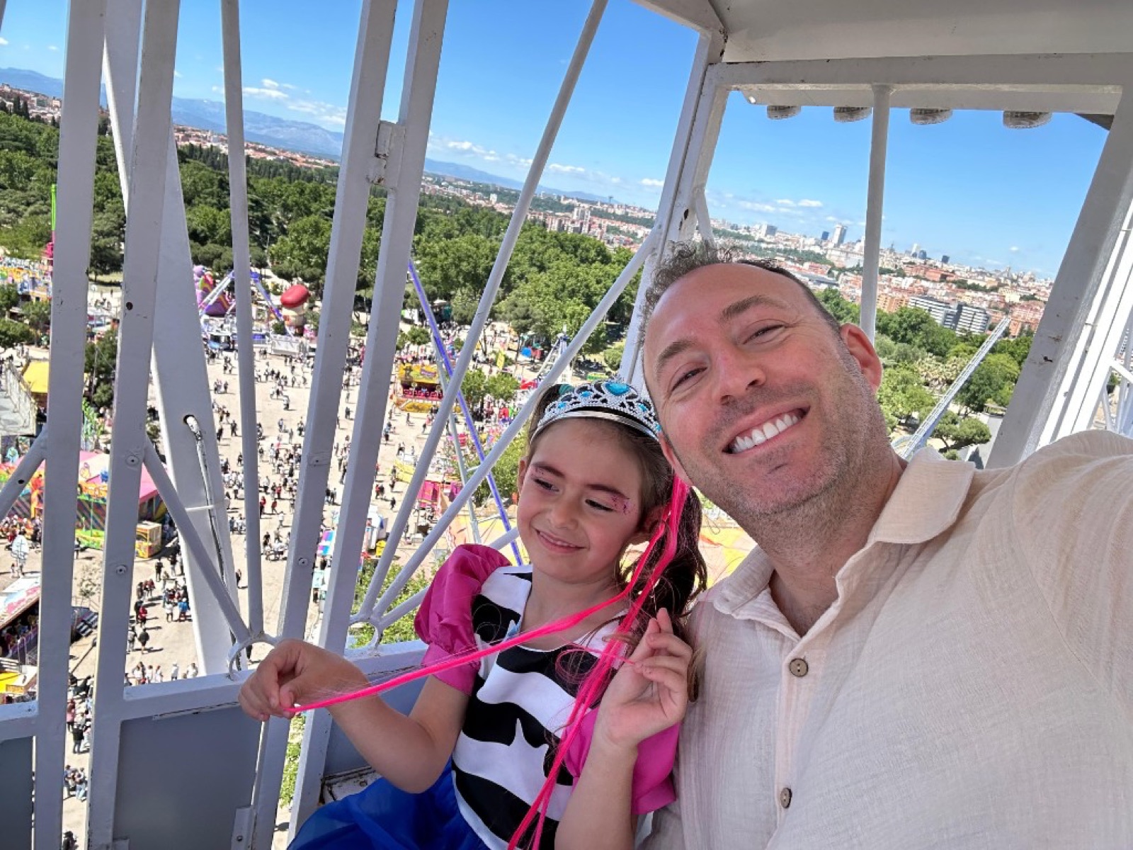 Mike and Billie on a ferris wheel above the city